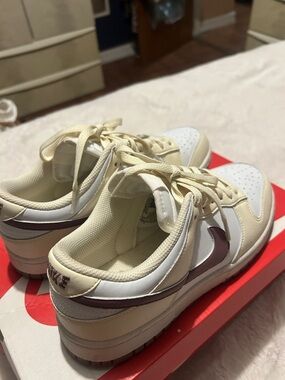 Nike Women’s Low-Top Sneakers in Cream with Plum Swoosh